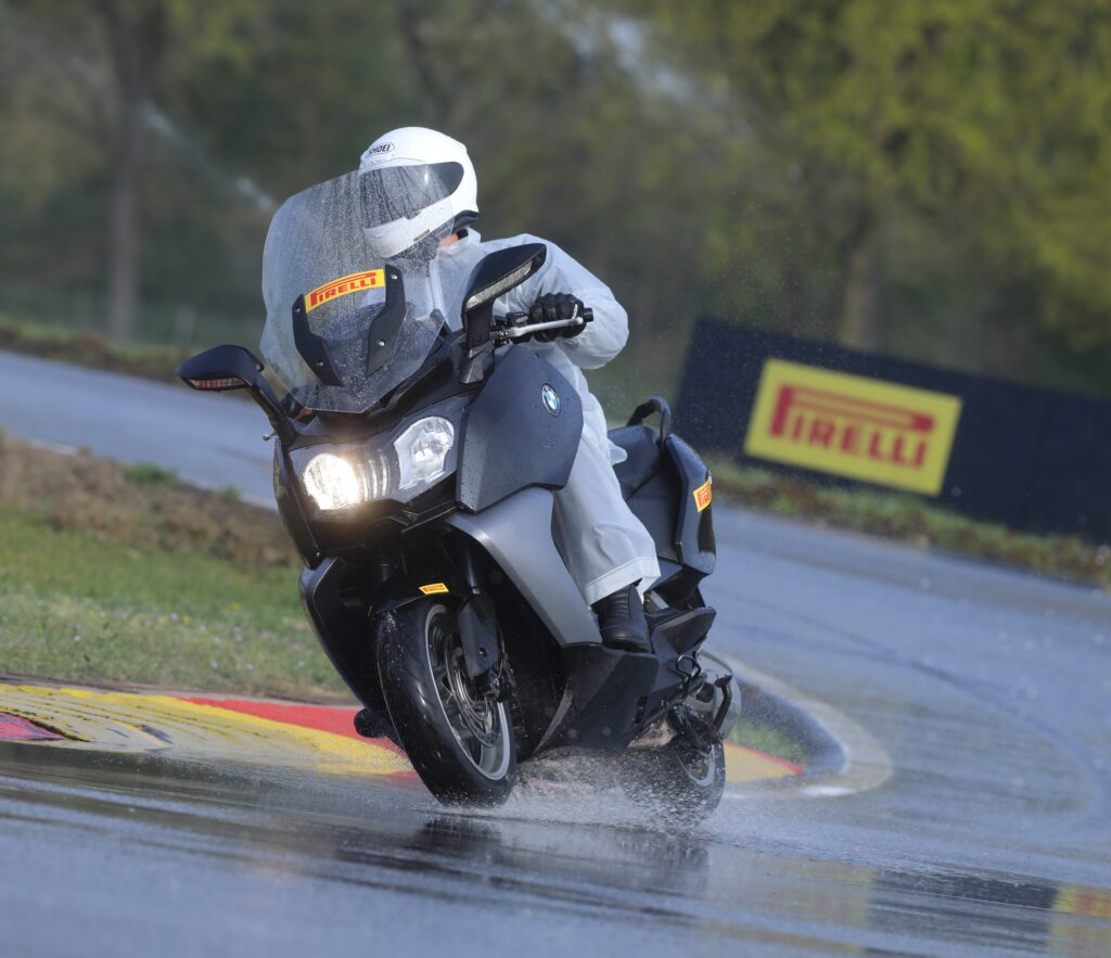 Scootertime’s editor‑in‑chief testing on wet conditions at the Pirelli Ticino Vizzola proving ground.