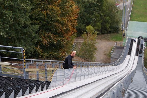 Schachermayr hoists a Vespa up a ski jumping hill. 