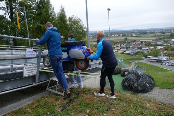 Schachermayr hoists a Vespa up a ski jumping hill. 