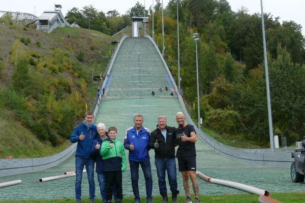 Schachermayr hoists a Vespa up a ski jumping hill.